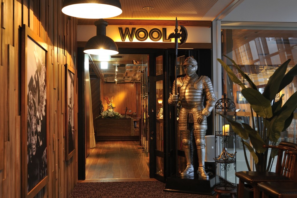 A stylish modern entrance with medieval armor on display.