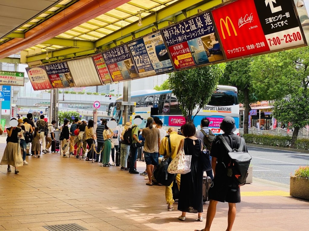 Look for the airport bus stop right in front of the shop.